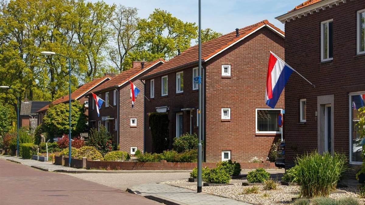 Gevel van een jaren 30-woning in Rotterdam met houten kozijnen en siermetselwerk